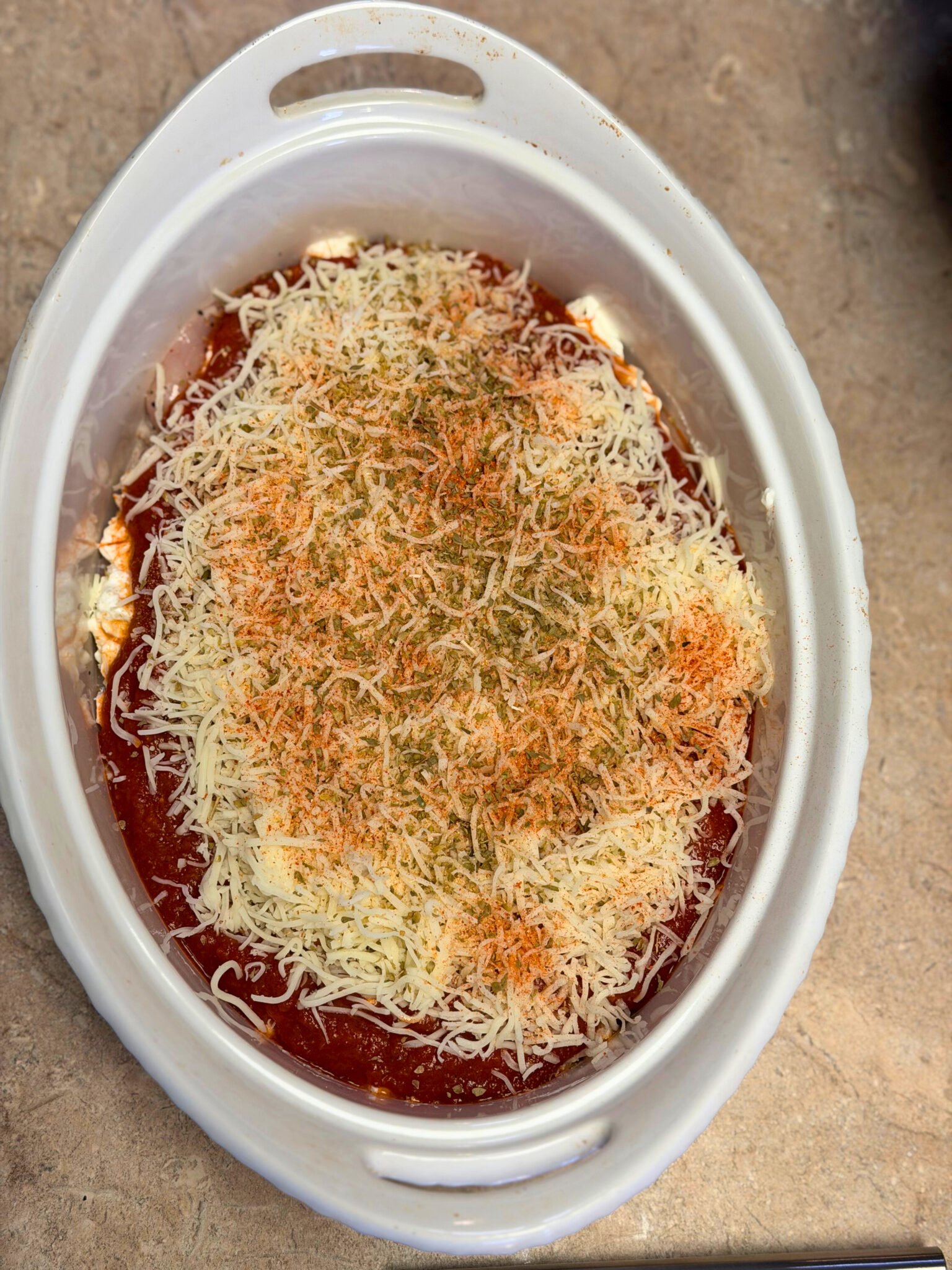 Low carb chicken parm casserole with marinara and melted cheese in a baking dish