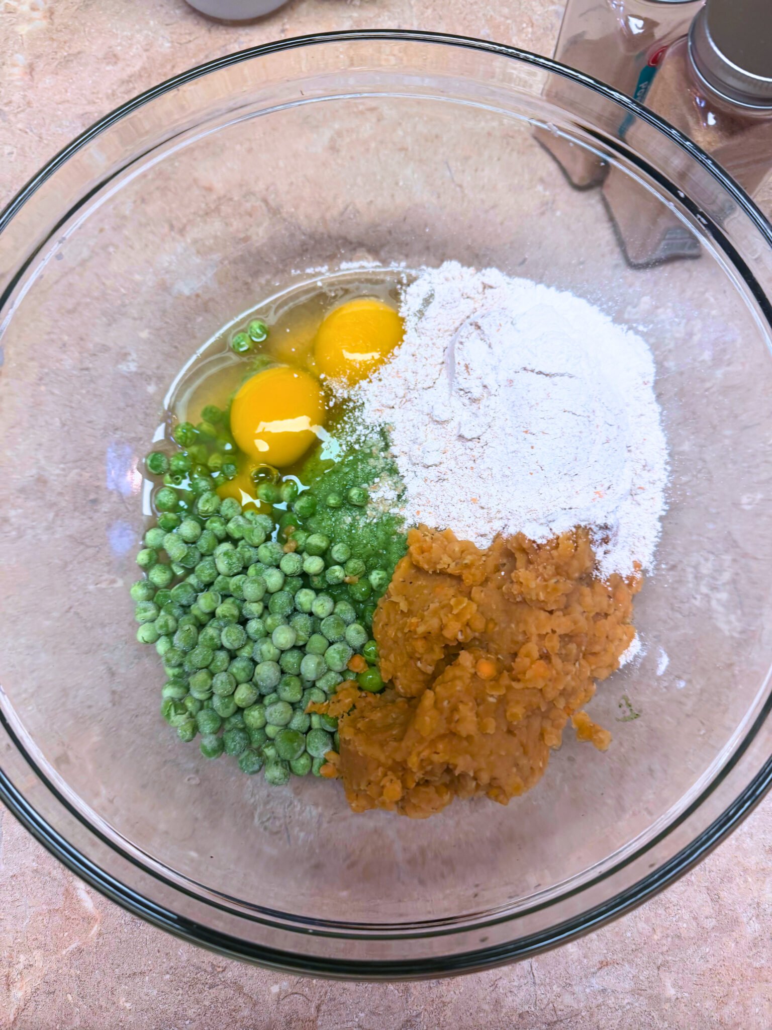 Close-up of a lentil veggie cup showing broccoli, peas, and lentil filling