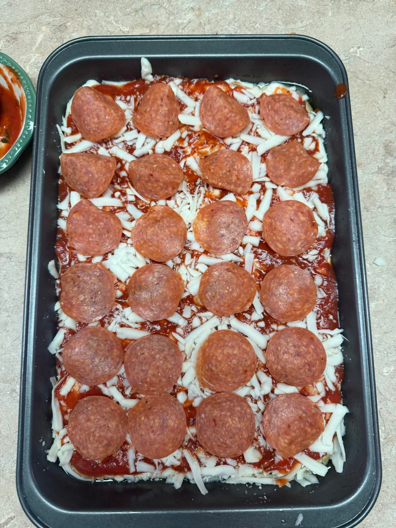 Detroit-style pizza fresh from oven with deeply golden caramelized frico cheese edges and racing stripe sauce