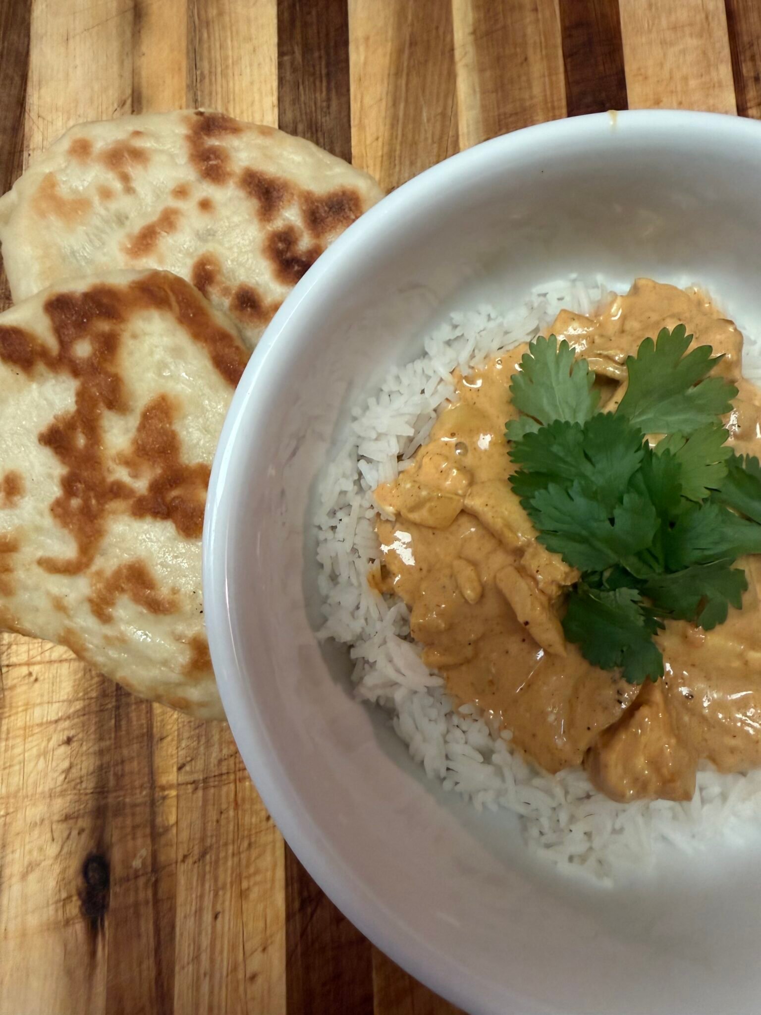 Easy creamy chicken curry served over fluffy white rice topped with cashews and fresh cilantro