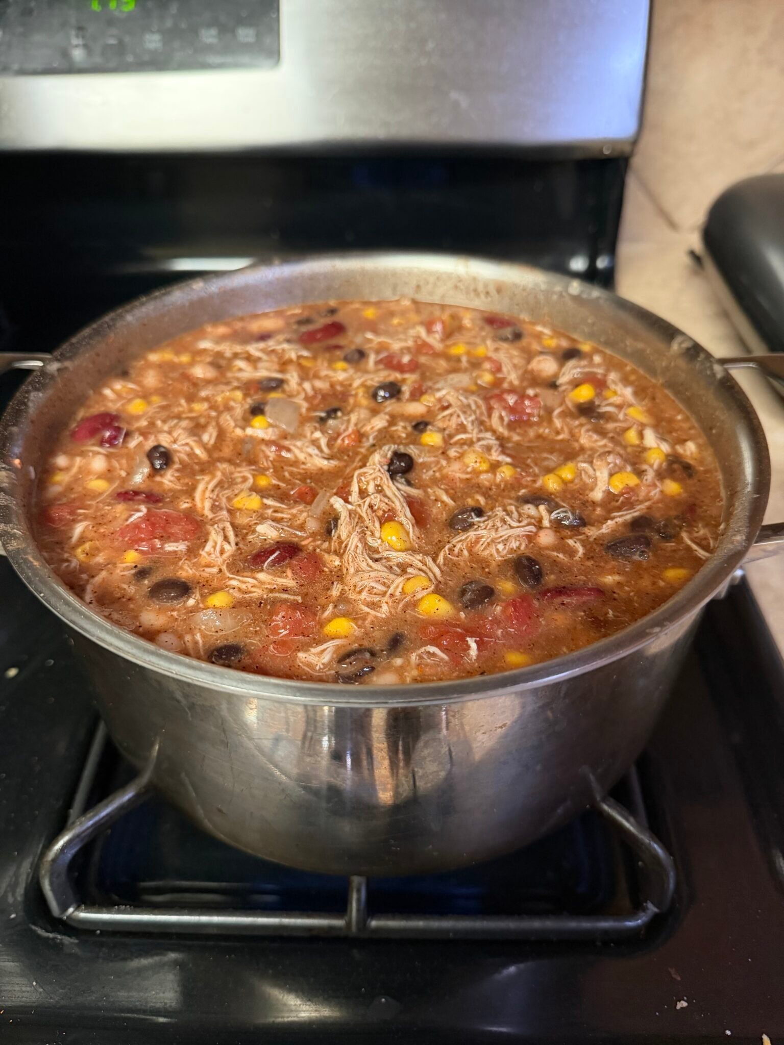 Easy chicken tortilla soup in a bowl with tortilla chips and toppings